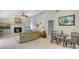 Open-concept living area featuring a fireplace, tile flooring, and a vaulted ceiling at 452 Picasso Dr, Nokomis, FL 34275