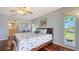 Bedroom with light blue walls, ensuite bath, and waterfront view at 452 Picasso Dr, Nokomis, FL 34275