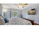 Bedroom with pool view, sliding glass door, and TV at 452 Picasso Dr, Nokomis, FL 34275