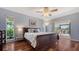 Bedroom with hardwood floors, natural light, and access to an outdoor lounge area at 452 Picasso Dr, Nokomis, FL 34275