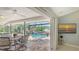 Outdoor dining and pool area featuring lush landscaping and waterfront views at 452 Picasso Dr, Nokomis, FL 34275