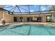 Relaxing pool area with travertine deck and easy access to both indoor and outdoor living spaces at 452 Picasso Dr, Nokomis, FL 34275
