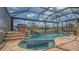 Beautiful screened-in pool with stone waterfall feature and inviting lounge area at 452 Picasso Dr, Nokomis, FL 34275