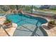 Relaxing waterfront pool with a spa, waterfall feature, and beautiful landscaping for serene outdoor living at 452 Picasso Dr, Nokomis, FL 34275