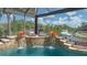 Stunning pool with a waterfall feature, patio seating and waterfront views of the boat dock for the ultimate outdoor enjoyment at 452 Picasso Dr, Nokomis, FL 34275