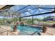 Picturesque pool area featuring a waterfall, lush landscaping, and views of the waterfront at 452 Picasso Dr, Nokomis, FL 34275