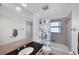 Bathroom with a black countertop sink, framed mirror, patterned shower curtain and tile floors at 4806 Huntleigh Dr, Sarasota, FL 34233
