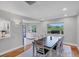 Open dining room showcases wood floors, a large table and access to the kitchen at 4806 Huntleigh Dr, Sarasota, FL 34233