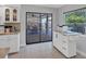Bright kitchen features white cabinets, granite countertops and access to screened in patio at 4806 Huntleigh Dr, Sarasota, FL 34233