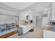 Bright kitchen features white cabinets, granite countertops, tile floors and stainless steel appliances at 4806 Huntleigh Dr, Sarasota, FL 34233