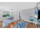 Open living room and dining area features hardwood floors and lots of natural light at 4806 Huntleigh Dr, Sarasota, FL 34233