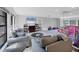 Expansive living area with a comfortable seating arrangement, large windows, and mirrored wall at 4806 Huntleigh Dr, Sarasota, FL 34233