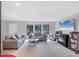 Bright living room with neutral decor, large windows, and comfortable seating at 4806 Huntleigh Dr, Sarasota, FL 34233