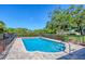 Fenced in backyard pool with a paved deck and lounge chairs at 4806 Huntleigh Dr, Sarasota, FL 34233