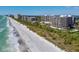 Stunning aerial view of beachfront condos, turquoise waters, and pristine white sand at 535 Sanctuary Dr # A602, Longboat Key, FL 34228