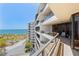 Stunning ocean view from a high-rise balcony with glass railings and outdoor seating at 535 Sanctuary Dr # A602, Longboat Key, FL 34228
