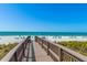 Scenic boardwalk leading to a beautiful white-sand beach with clear blue ocean waters at 535 Sanctuary Dr # A602, Longboat Key, FL 34228