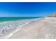 Expansive beach view featuring pristine white sand and clear turquoise water on a bright sunny day at 535 Sanctuary Dr # A602, Longboat Key, FL 34228