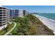 Picturesque beach and waterfront condos, complete with swaying palm trees and manicured lawns at 535 Sanctuary Dr # A602, Longboat Key, FL 34228