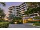 Elegant building exterior with lush landscaping and circular driveway at 535 Sanctuary Dr # A602, Longboat Key, FL 34228