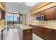 Well-appointed kitchen with granite countertops, stainless steel appliances, and sliding glass doors leading to an outdoor space at 535 Sanctuary Dr # A602, Longboat Key, FL 34228