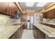 Modern kitchen with custom cabinetry, granite countertops, stainless steel appliances, and a spacious center island at 535 Sanctuary Dr # A602, Longboat Key, FL 34228