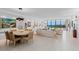 Open-concept living room features ocean view and dining area with modern decor at 535 Sanctuary Dr # A602, Longboat Key, FL 34228