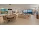 Open-concept living room features ocean view and dining area with modern decor at 535 Sanctuary Dr # A602, Longboat Key, FL 34228
