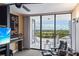 Spacious living room features sliding glass doors that open to a balcony with green views at 535 Sanctuary Dr # A602, Longboat Key, FL 34228