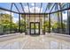 Sunny lobby with glass ceiling and natural light, featuring benches and greenery at 535 Sanctuary Dr # A602, Longboat Key, FL 34228