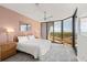 Bright, spacious main bedroom featuring balcony access and wicker furniture at 535 Sanctuary Dr # A602, Longboat Key, FL 34228