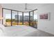 Bright main bedroom features large glass sliding doors leading to a balcony with water views at 535 Sanctuary Dr # A602, Longboat Key, FL 34228