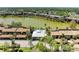 Stunning aerial view of waterfront community with private pools and lush landscaping near a serene lake at 5395 Lake Arrowhead Trl # 24, Sarasota, FL 34231