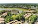 Aerial view of the community featuring lake and lush, mature trees throughout at 5395 Lake Arrowhead Trl # 24, Sarasota, FL 34231