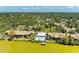 Aerial view featuring lakefront community, private pool, dock, and verdant surroundings, creating a tranquil living space at 5395 Lake Arrowhead Trl # 24, Sarasota, FL 34231