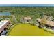 Scenic aerial view of condo community surrounded by lush landscaping and a beautiful lake at 5395 Lake Arrowhead Trl # 24, Sarasota, FL 34231