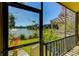 Relaxing balcony view overlooking a serene lake and lush greenery at 5395 Lake Arrowhead Trl # 24, Sarasota, FL 34231