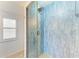 Stylish bathroom shower featuring modern glass enclosure and blue tiled walls at 5395 Lake Arrowhead Trl # 24, Sarasota, FL 34231