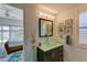 Stylish bathroom featuring a unique glass bowl sink and decorative coastal themed artwork at 5395 Lake Arrowhead Trl # 24, Sarasota, FL 34231