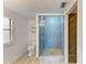 Bright bathroom features a glass enclosed shower with pebble stone floor and modern fixtures at 5395 Lake Arrowhead Trl # 24, Sarasota, FL 34231