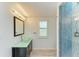 Bathroom features a vessel sink, sleek vanity, and a modern shower with blue accents at 5395 Lake Arrowhead Trl # 24, Sarasota, FL 34231