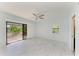 Bright bedroom features a ceiling fan, a sliding glass door to a deck, and a window with blind at 5395 Lake Arrowhead Trl # 24, Sarasota, FL 34231