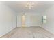 Spacious bedroom with soft carpeting, modern chandelier and closet with white doors at 5395 Lake Arrowhead Trl # 24, Sarasota, FL 34231