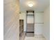 Well-organized walk-in closet with custom shelves, drawers, and stylish wood accent wall at 5395 Lake Arrowhead Trl # 24, Sarasota, FL 34231