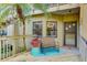Inviting front porch with seating area, a palm tree and a welcoming entrance to the home at 5395 Lake Arrowhead Trl # 24, Sarasota, FL 34231