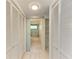 Hallway view of closets and bathroom featuring a tub with glass doors and marble tile at 5395 Lake Arrowhead Trl # 24, Sarasota, FL 34231