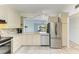 Bright kitchen with stainless steel appliances, light countertops, and view to the outdoor patio at 5395 Lake Arrowhead Trl # 24, Sarasota, FL 34231