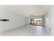 Spacious living room with light wood floors, lake views, and sliding glass doors to the outside at 5395 Lake Arrowhead Trl # 24, Sarasota, FL 34231