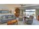Inviting living room with comfortable seating and tranquil lake views from the sliding glass doors at 5395 Lake Arrowhead Trl # 24, Sarasota, FL 34231