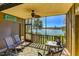 Relaxing screened porch with seating and serene lake views, ideal for enjoying the outdoors at 5395 Lake Arrowhead Trl # 24, Sarasota, FL 34231
